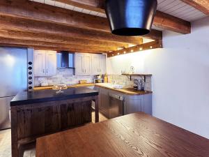a kitchen with a wooden counter top in a room at Exceptional Duplex, Cozy & Authentic Atmosphere in Les Gets