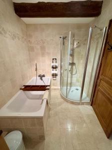 a bathroom with a shower and a tub and a sink at Exceptional Duplex, Cozy & Authentic Atmosphere in Les Gets +30 photos