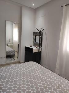 a bedroom with a bed and a large mirror at Panamera 8 in Sousse