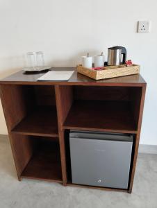 a wooden desk with a microwave under it at White House Tangalle in Tangalle