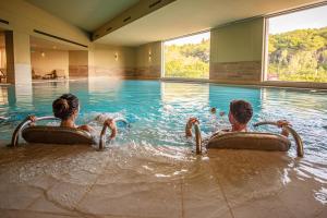two people in the water in a swimming pool at Basiliani - CDSHotels in Otranto +59 photos