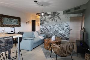 a living room with a couch and a table at I Salini - T3 élégant & calme près du centre - Classé 4 étoiles in Porto-Vecchio