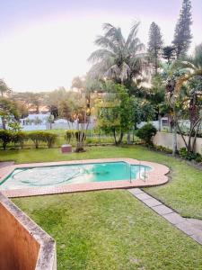 a swimming pool in the yard of a house at 12th on The Bay Apartment in Richards Bay