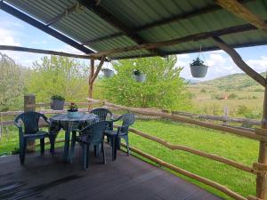 a patio with a table and chairs on a deck at Csendàr hàz in Tapolca