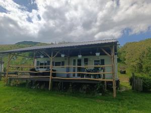a house with a large deck in a field at Csendàr hàz in Tapolca