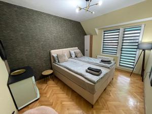 a small bedroom with a bed and a window at BM Aparts Rustic in Pleven