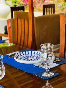 a table with a plate and a wine glass on it at Nature's Edge Udawalawa in Sinuggala