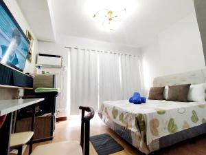 a bedroom with a bed with a blue stuffed animal on it at Convenient Condo - Nearby CDO Mall in Pontud