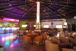 a restaurant with chairs and tables and a ceiling with purple lights at Sun Hotel and Resort, Mount Abu in Ābu Road +111 photos