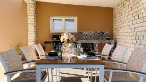a table with a vase of flowers on it at Apartments King and Queen 2 in Povile