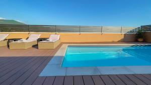 a swimming pool on the roof of a building at Apartments King and Queen 2 in Povile