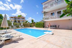 a villa with a swimming pool in front of a house at Villa Zante Odysseus in Planos
