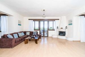 a living room with a couch and a table at Villa Zante Odysseus in Planos