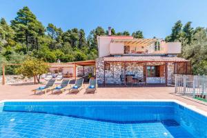 a villa with a swimming pool and a house at Villa Terracotta in Alikias