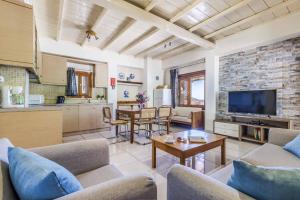 a living room with a couch and a table at Villa Terracotta in Alikias