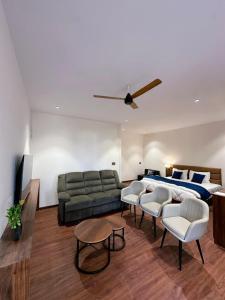 a living room with a couch and a bed at Hulara Meadows in Lucknow
