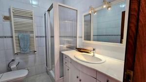 a white bathroom with a sink and a mirror at Casa Lu in Salir de Porto +43 photos