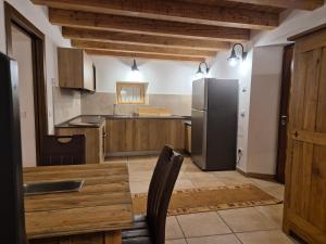 a kitchen with a black refrigerator and a table at Dimora del Serva in Belluno