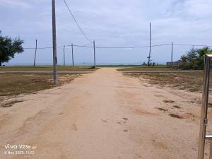 a dirt road with a pole in the middle at Makok Seaview roomstay in Kampung Penarik