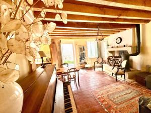 a living room with a table and chairs at Sweet Pea Cottage in Donzy