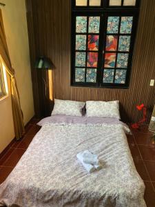 a bedroom with two beds and a window at Maison MAY Đà Lạt in Da Lat