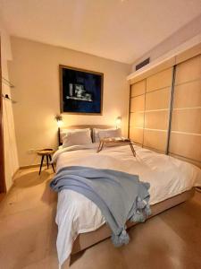 a bedroom with a large white bed in a room at Andromeda Sunset Suite & Spa in Tel Aviv +34 photos
