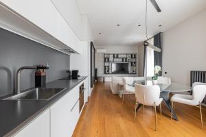 a kitchen and dining room with a table and chairs at Luxury Calzolerie in Bologna