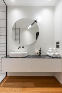 a bathroom with a sink and a mirror at Luxury Calzolerie in Bologna +22 photos