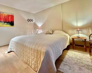a bedroom with a bed with a white bedspread at Les Ruisseaux in Gedinne