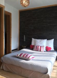 a bedroom with a large bed with red pillows at Appartement le Saint James in Nice