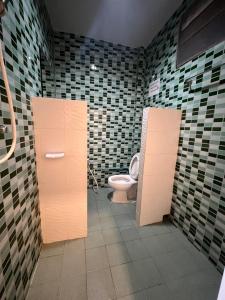 a bathroom with a toilet and tiled walls at ใบไม้ in Ko Si Chang +27 photos