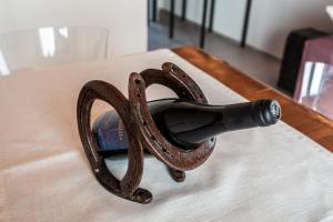 a bottle of wine sitting on top of a table at LVguesthouse in Priocca