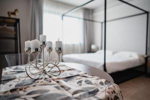 a room with a table with candles and a bed at LVguesthouse in Priocca