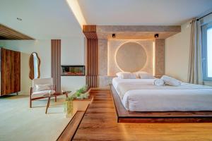 a large bedroom with a large bed and a chair at Suite Moon & Spa in Amnéville