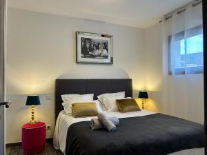 a bedroom with a large bed with two pillows at Residence Capriona in Porto Pollo