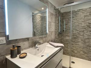 a white bathroom with a sink and a mirror at Residence Capriona in Porto Pollo +100 photos