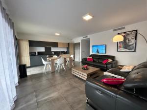 a living room with a couch and a table at Residence Capriona in Porto Pollo