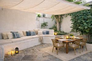 a living room with a couch and a table at Yades House Paros in Naousa
