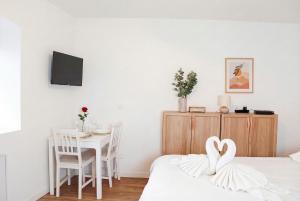 a bedroom with two swans sitting on a bed at Chic Home - Turckheim in Turckheim