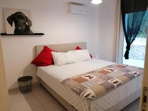 a bedroom with a bed with a dog on the wall at Villa M&M met eigen zwembad in Kalamaki +16 photos