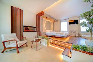 a living room with a bed and a couch at Suite Moon & Spa in Amnéville