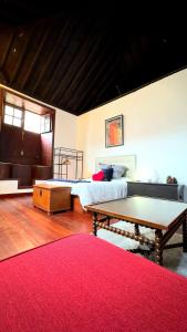 a bedroom with a bed and a table with a ping at Caleton-Gara-Suites in Garachico