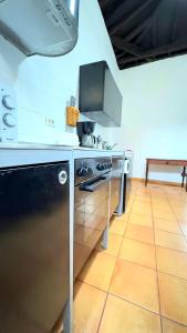 a kitchen with a stove and a counter top at Caleton-Gara-Suites in Garachico +25 photos