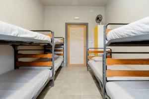 a room with three bunk beds and a door at Alarpe Aterpetxea BSS00035 in Zaldivia +11 photos