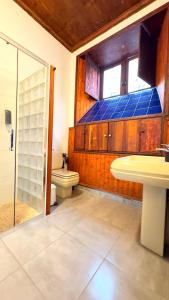 a bathroom with a toilet and a sink and a shower at Caleton-Gara-Suites in Garachico