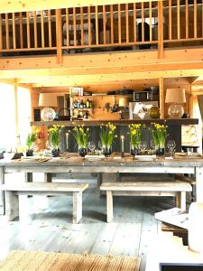 a large wooden table with benches in a room at Shackmatack in Tenants Harbor