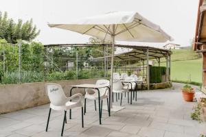 a group of tables and chairs with an umbrella at Alarpe Aterpetxea BSS00035 in Zaldivia