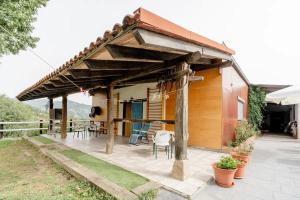 a house with a wooden roof with a patio at Alarpe Aterpetxea BSS00035 in Zaldivia