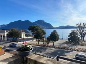 a view of a street and a lake with mountains at Casa Caterina in Intra