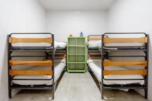 a room with three bunk beds and a green cabinet at Alarpe Aterpetxea BSS00035 in Zaldivia
